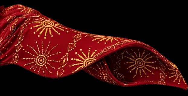 Tela estampada en rojo con motivos solares dorados.